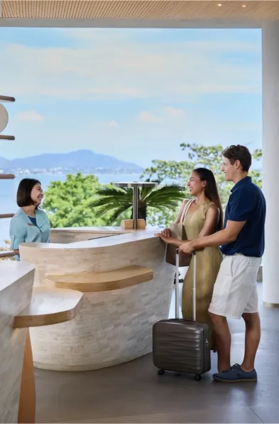 Couple checking in at a resort reception desk